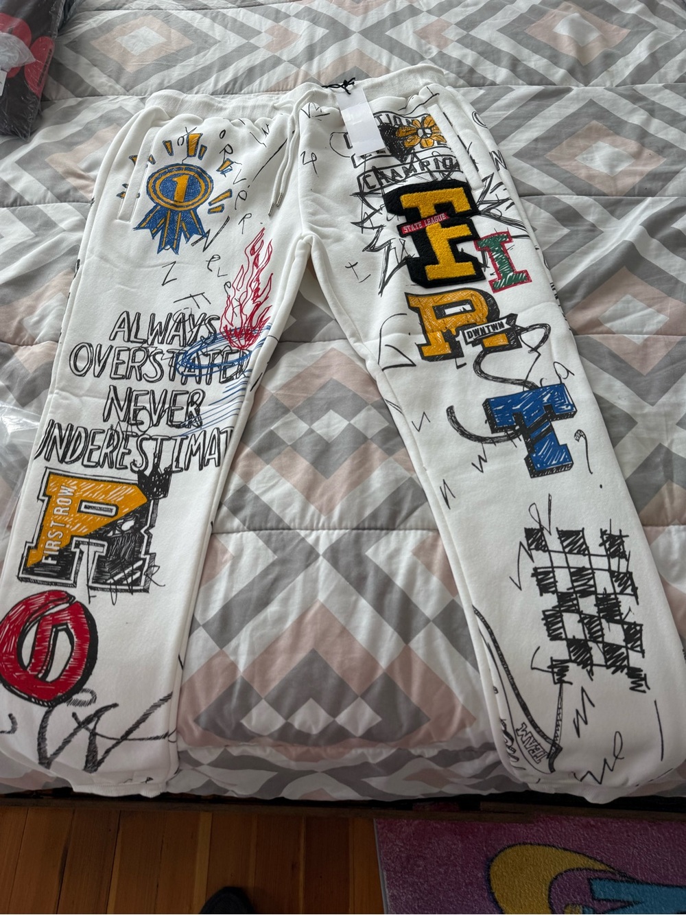 First Row White Graphic Drawstring Sweatpants with Multi-Color Designs - Picture 2 of 5